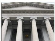 AGTA Continues the Fight for Zero Tariffs: Thailand and Vietnam Look to be Next Two people standing in front of large classical columns outside a building.