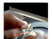 GIA Announces “Jewelry Forensics” – Techniques to Determine Manufacturing Style, Jewelry Quality, and Repair History. Person examining a gemstone with a loupe under bright light.
