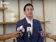 The Gem and Jewelry Institute of Thailand (GIT) Posts Rising Exports as Trump Announces More Tariffs (Aug. 1), and Thailand is on the List! A man in a blue suit speaking to reporters with microphones.