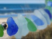 “Gems” on the Beach – aka… Sea Glass: It’s a Treasure “for Shore” – Perfect for the Summer! Colorful sea glass pieces hanging on a string by the ocean.