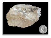 GIA Examines Motswedi: World’s 2nd Largest Gem Quality Rough Diamond Crystal A large translucent crystal next to a quarter for scale.