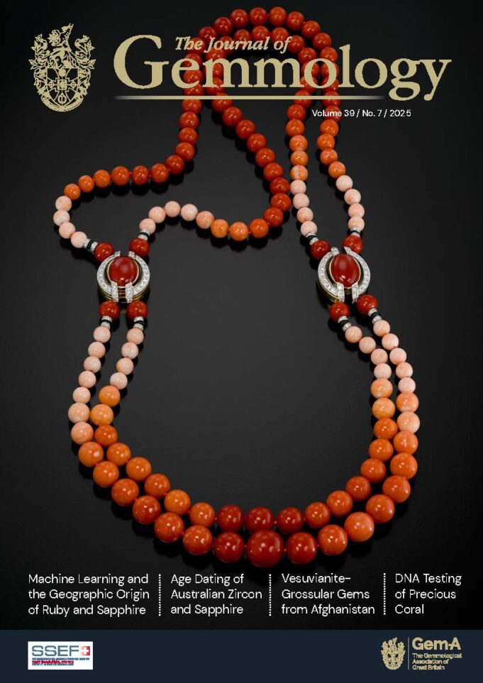Cover JoG2025_39_7 Elegant beaded necklace with red and peach tones and silver accents.