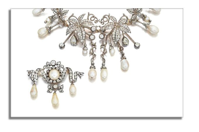 Intricate vintage pearl necklace with matching brooch.