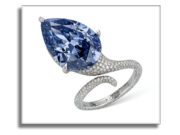 Christie’s Geneva Magnificent Jewels: Featuring the Mellon Blue and the Rainbow Collection Elegant ring with a large pear-shaped blue gemstone and diamond-studded band.